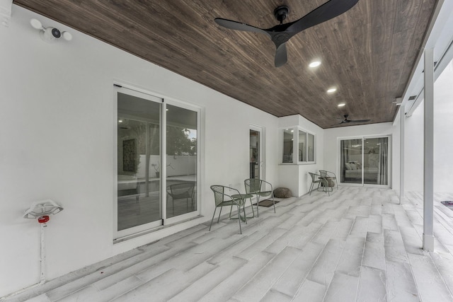 wooden deck featuring ceiling fan and a patio area