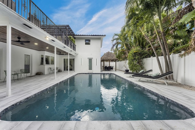 view of swimming pool with ceiling fan and a patio area