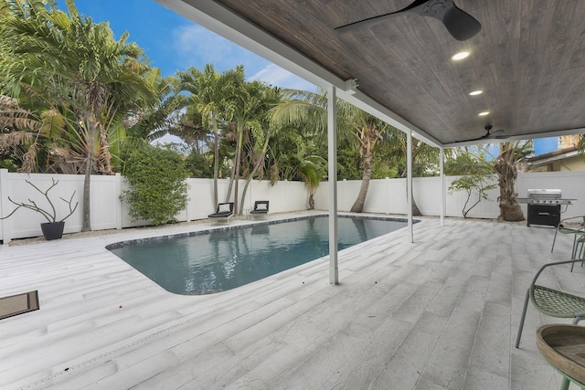 view of swimming pool featuring grilling area and ceiling fan