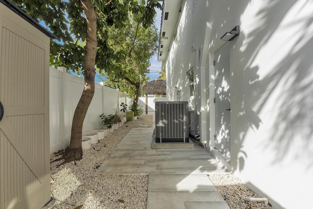 view of home's exterior with cooling unit and a patio