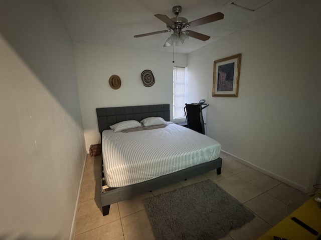 tiled bedroom with ceiling fan