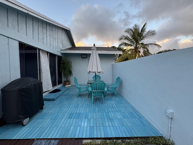 deck at dusk with a grill