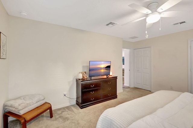 carpeted bedroom with ceiling fan and a closet