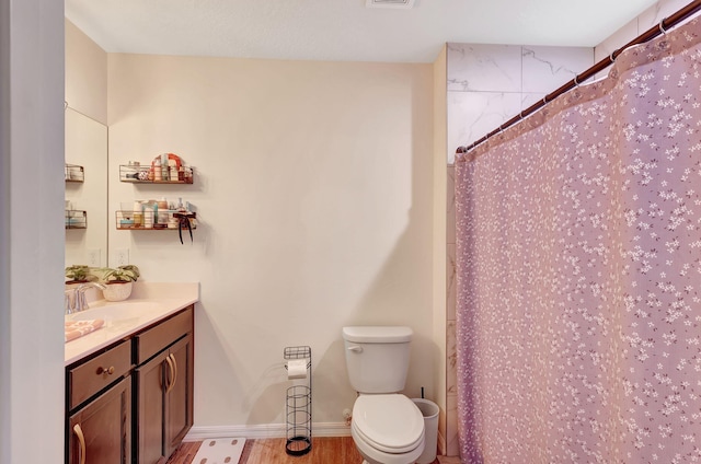 bathroom featuring vanity, toilet, a shower with shower curtain, and hardwood / wood-style flooring