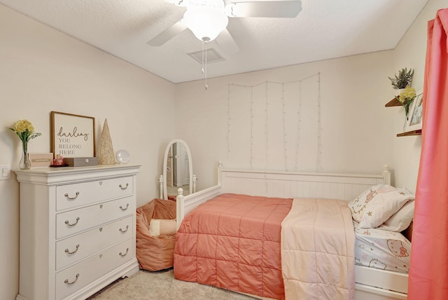 bedroom with carpet flooring, a textured ceiling, and ceiling fan