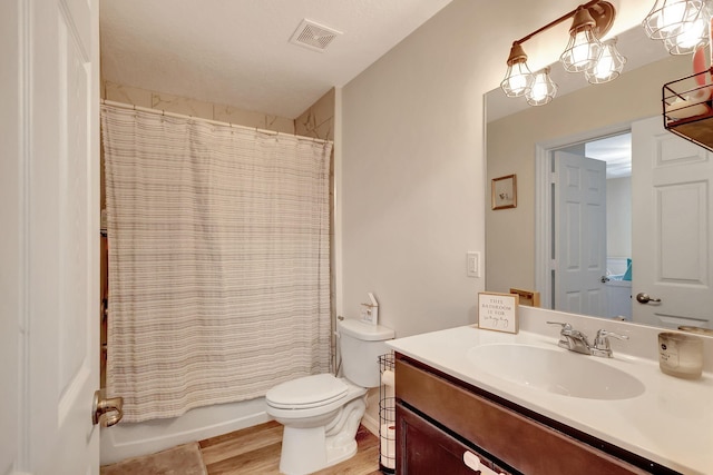 full bathroom featuring shower / bathtub combination with curtain, hardwood / wood-style floors, vanity, and toilet