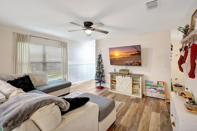 living room with ceiling fan and hardwood / wood-style floors