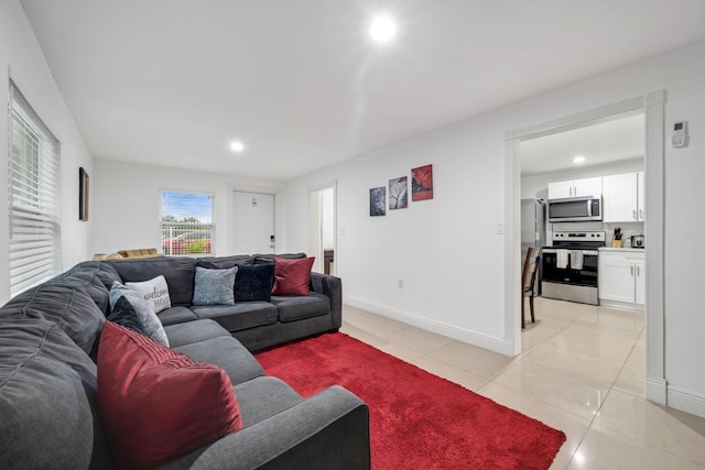 2365 NW 68th St, Miami, FL 33147 - living area featuring light tile patterned floors, recessed lighting, and baseboards