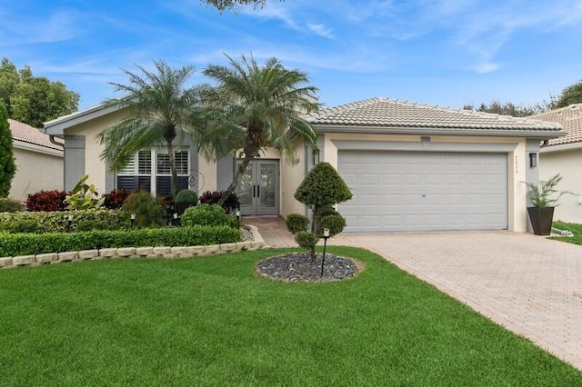 ranch-style home with a garage and a front lawn