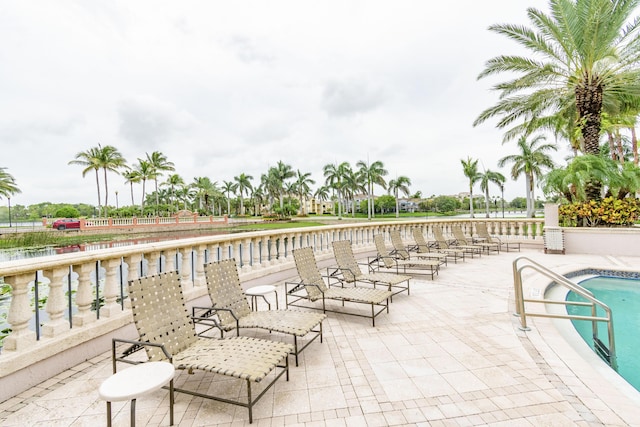 view of patio featuring a water view and a swimming pool