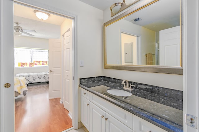 bathroom featuring vanity, ceiling fan, and wood-type flooring