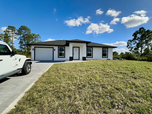 view of front of home featuring a garage and a front yard