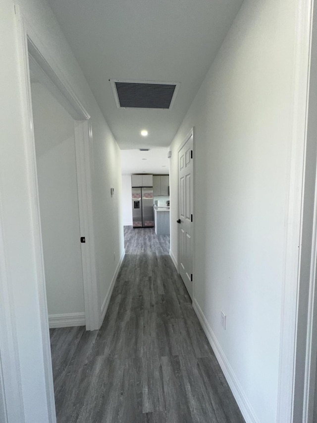 hallway with dark hardwood / wood-style floors