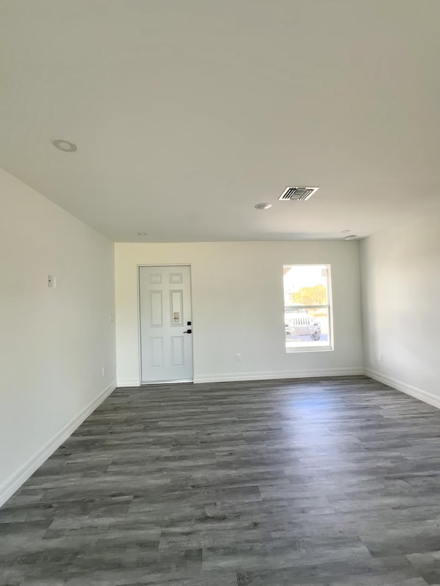 spare room with dark hardwood / wood-style floors