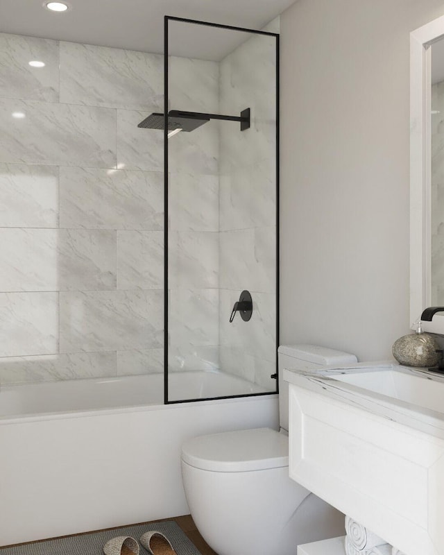 full bathroom with vanity, toilet, and tiled shower / bath