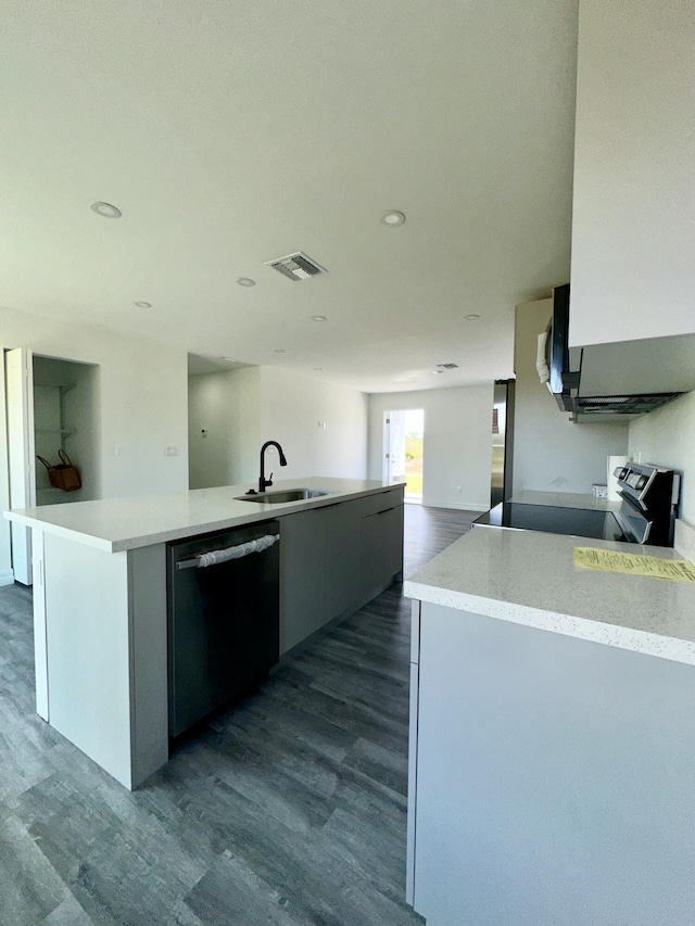 kitchen featuring sink, black dishwasher, an island with sink, dark hardwood / wood-style flooring, and stainless steel electric stove