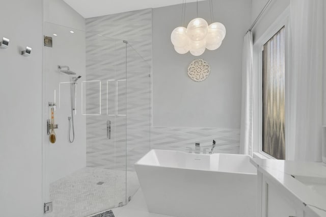 bathroom featuring vanity, tile walls, and independent shower and bath