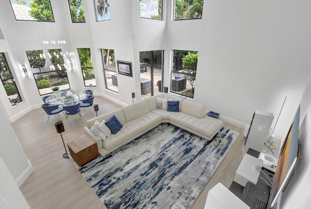 living room with a high ceiling and a wealth of natural light