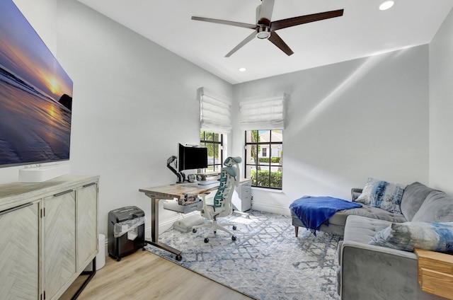 office with ceiling fan and light hardwood / wood-style floors