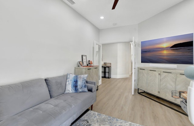 living room featuring ceiling fan and light hardwood / wood-style floors