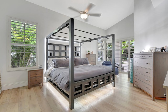 bedroom with ceiling fan, light hardwood / wood-style flooring, and high vaulted ceiling