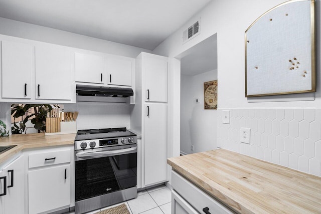 kitchen featuring light tile patterned floors, white cabinets, and stainless steel range oven