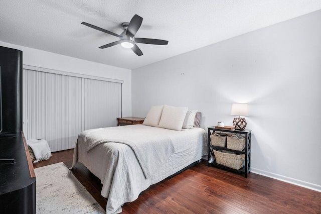 bedroom featuring a textured ceiling, ceiling fan, and dark hardwood / wood-style floors