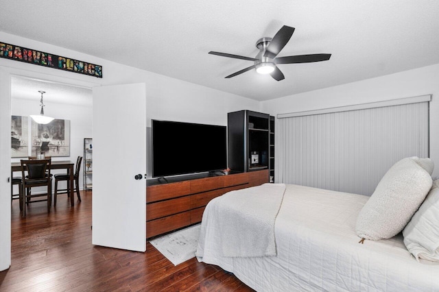 bedroom featuring a textured ceiling, dark hardwood / wood-style flooring, and ceiling fan