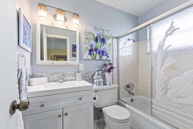 full bathroom featuring tasteful backsplash, shower / bath combination with glass door, vanity, and toilet