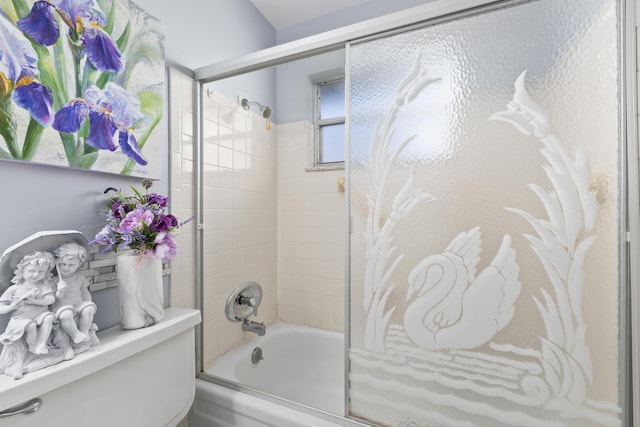 bathroom featuring shower / bath combination with glass door and toilet