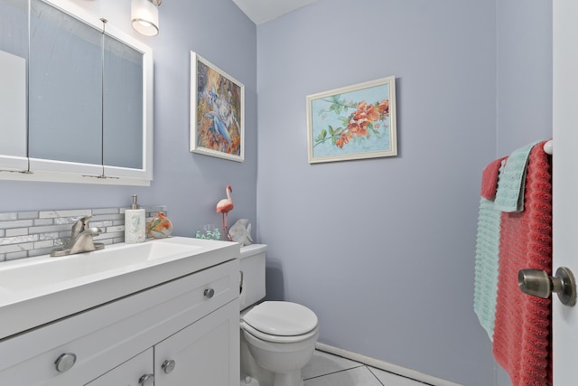 bathroom featuring toilet, vanity, and tile patterned floors