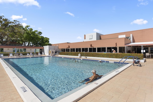 view of swimming pool featuring a patio area