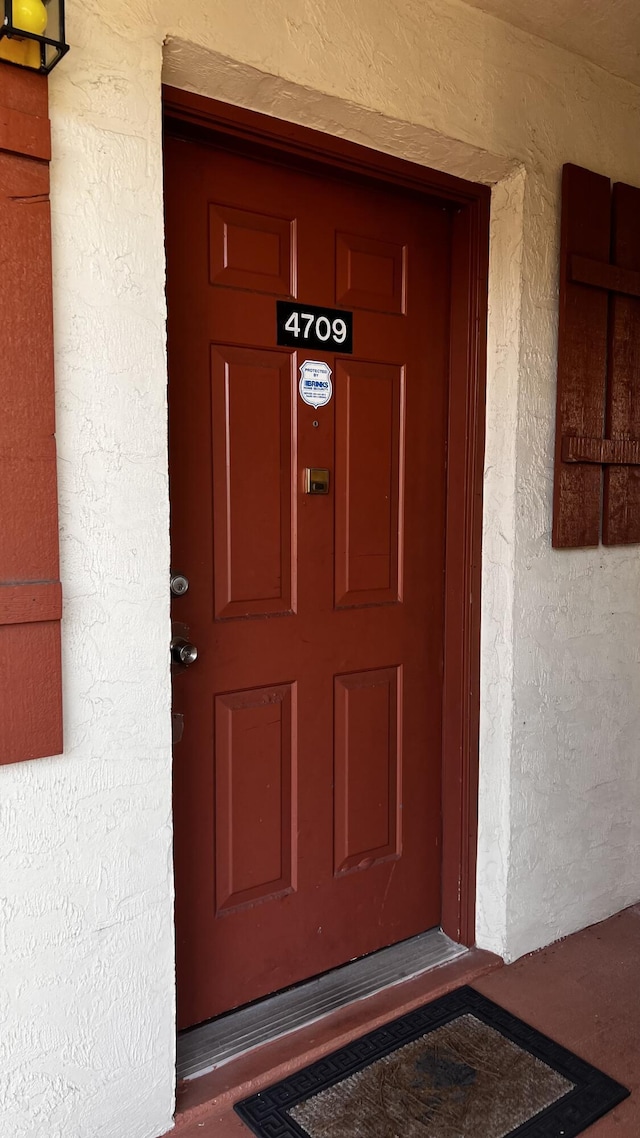 doorway to property with stucco siding