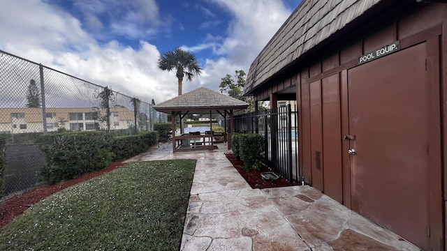 view of patio with a gazebo and fence