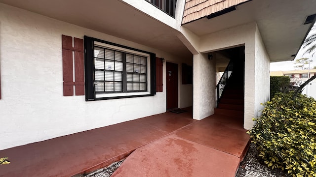 view of exterior entry with stucco siding