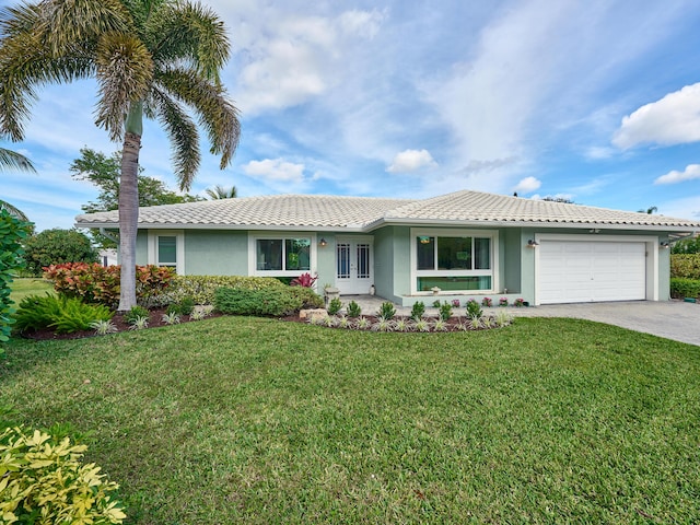 single story home featuring a garage and a front yard