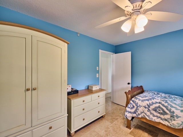 bedroom featuring access to outside, ceiling fan, and a textured ceiling