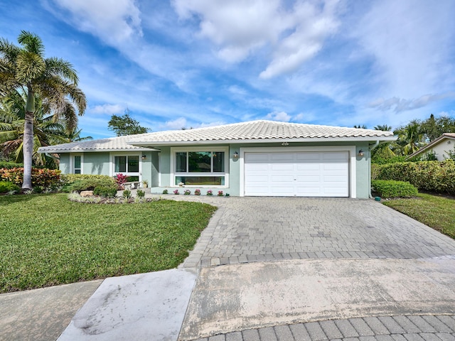 single story home with a front yard and a garage