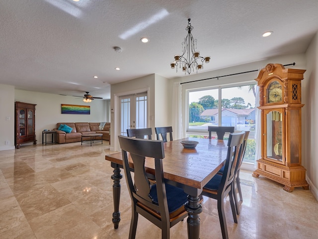 living room with ceiling fan, french doors, and a textured ceiling