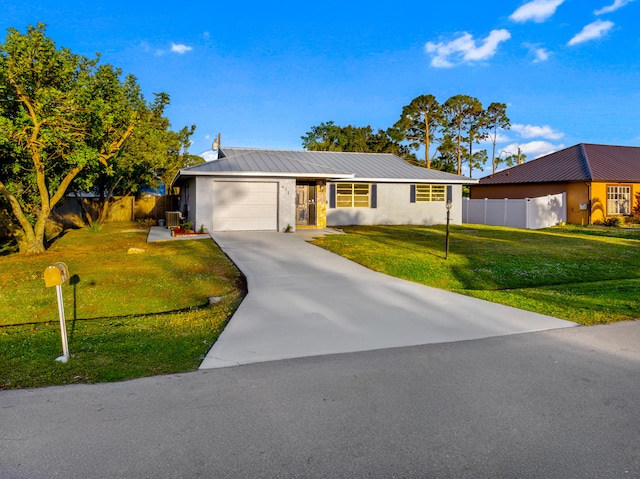 ranch-style home with a front lawn, central AC unit, and a garage