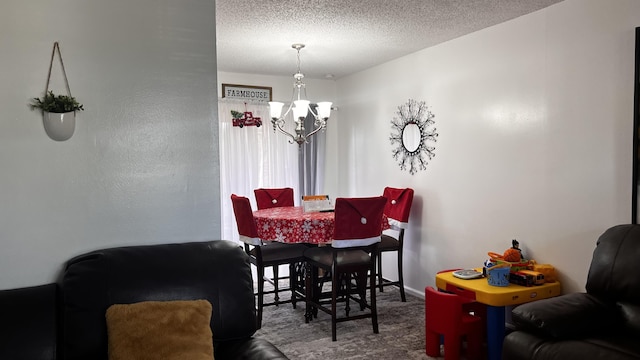 dining room featuring a chandelier and a textured ceiling