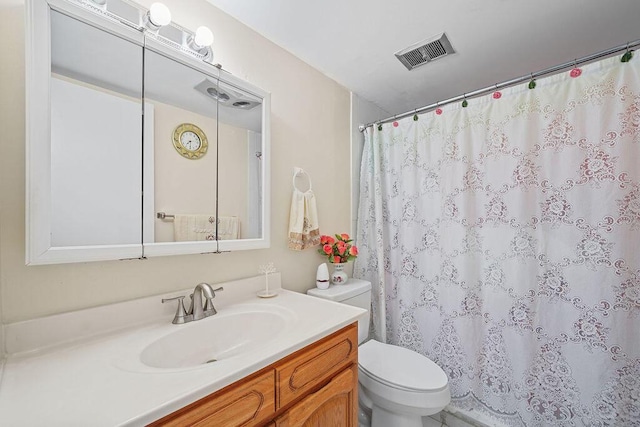 bathroom with vanity, a shower with shower curtain, and toilet