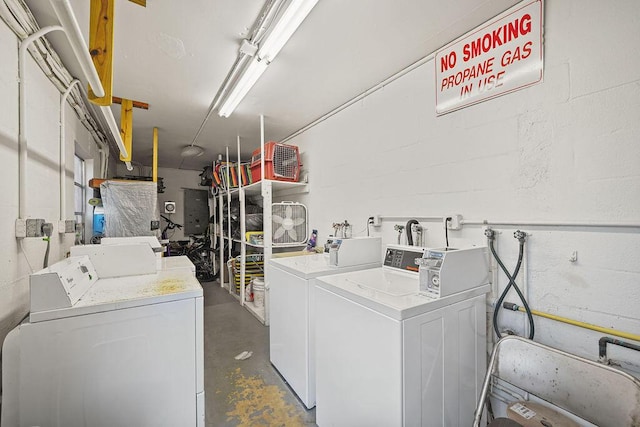 washroom with washing machine and clothes dryer and sink