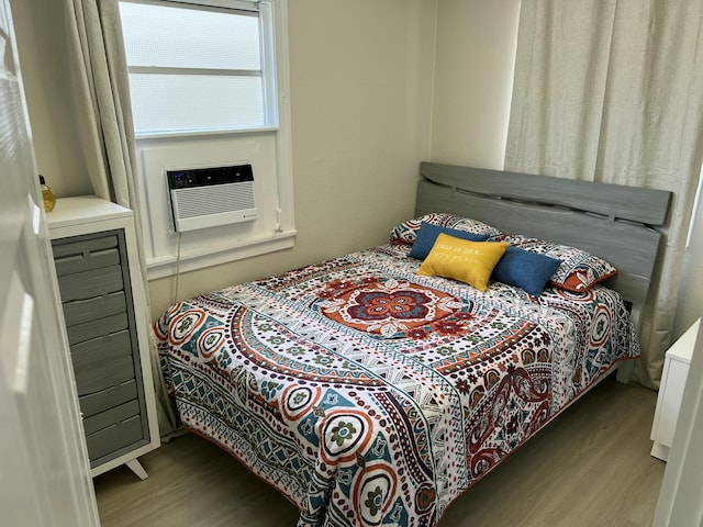 bedroom featuring cooling unit and wood-type flooring