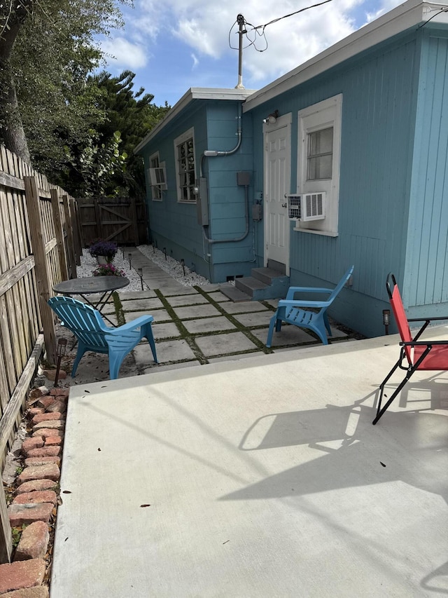 rear view of house featuring a patio area and cooling unit