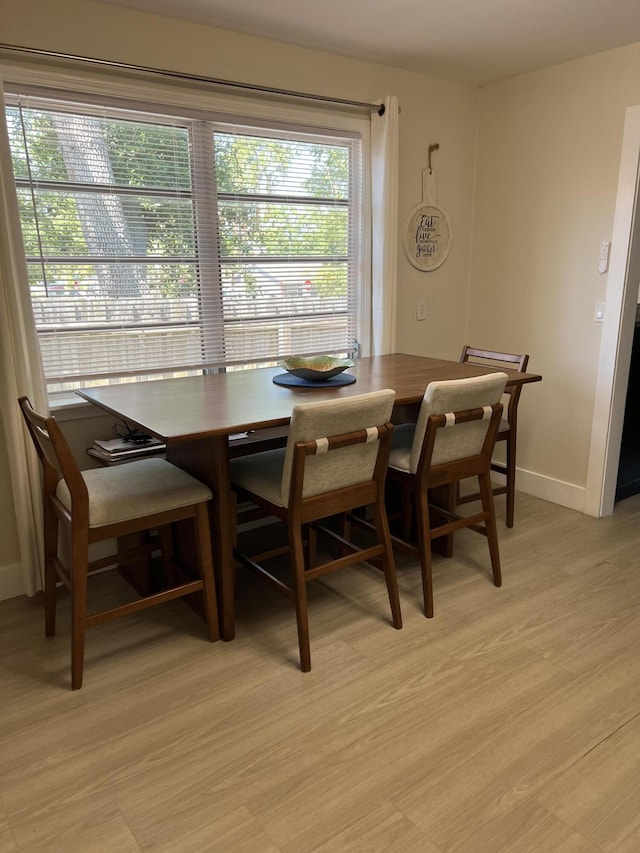 dining space with light hardwood / wood-style flooring