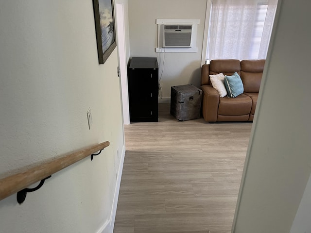 corridor featuring a wall unit AC and light hardwood / wood-style flooring