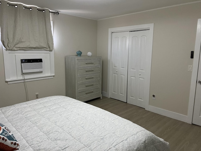 bedroom with hardwood / wood-style flooring, a closet, and ornamental molding