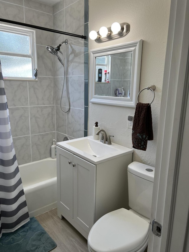 full bathroom with hardwood / wood-style floors, vanity, toilet, and shower / bathtub combination with curtain