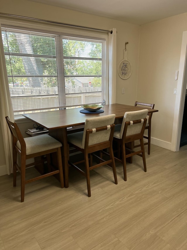 dining area with light hardwood / wood-style flooring